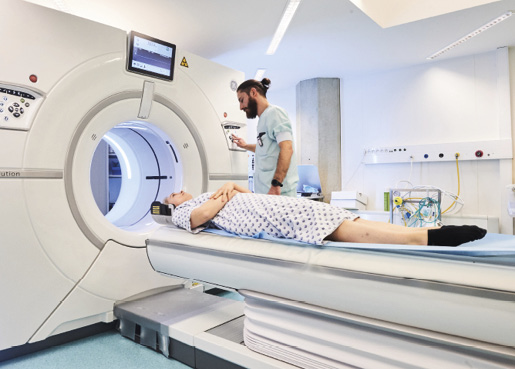 Egy egészségügyi szakember MRI-vizsgálatot végez egy betegen.