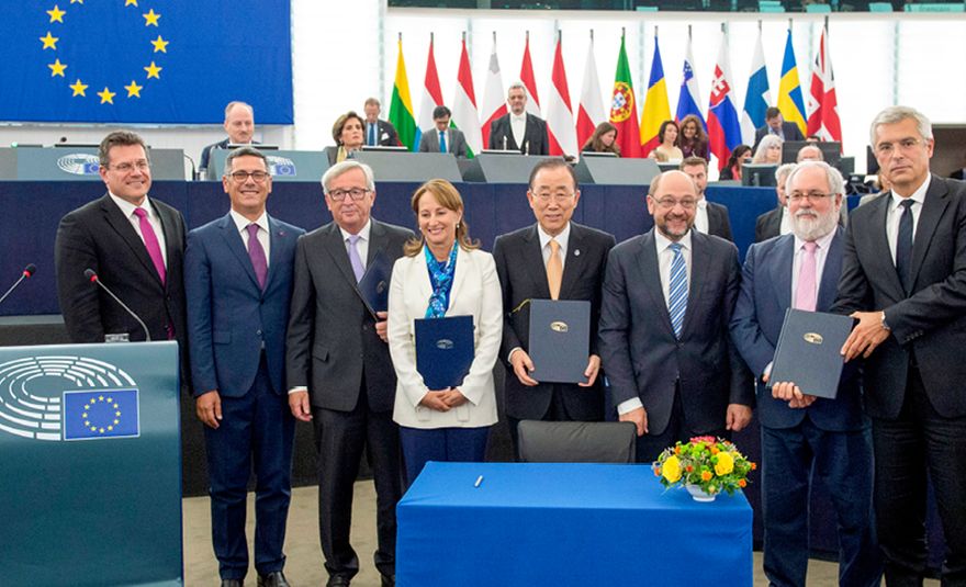 Imagem: Maroš Šefčovič, vice-presidente da Comissão, Giovanni La Via, deputado do Parlamento Europeu, Jean-Claude Juncker, presidente da Comissão Europeia, Ségolène Royal, ministra francesa do Ambiente, da Energia e do Mar, Ban Ki-moon, secretário-geral das Nações Unidas, Martin Schulz, presidente do Parlamento Europeu, o comissário Miguel Arias Cañete e Ivan Korčok, secretário de Estado do Ministério dos Negócios Estrangeiros e dos Assuntos Europeus da Eslováquia, na cerimónia de assinatura da ratificação pela UE do Acordo de Paris sobre as alterações climáticas, em Estrasburgo, França, em 4 de outubro de 2016. © União Europeia