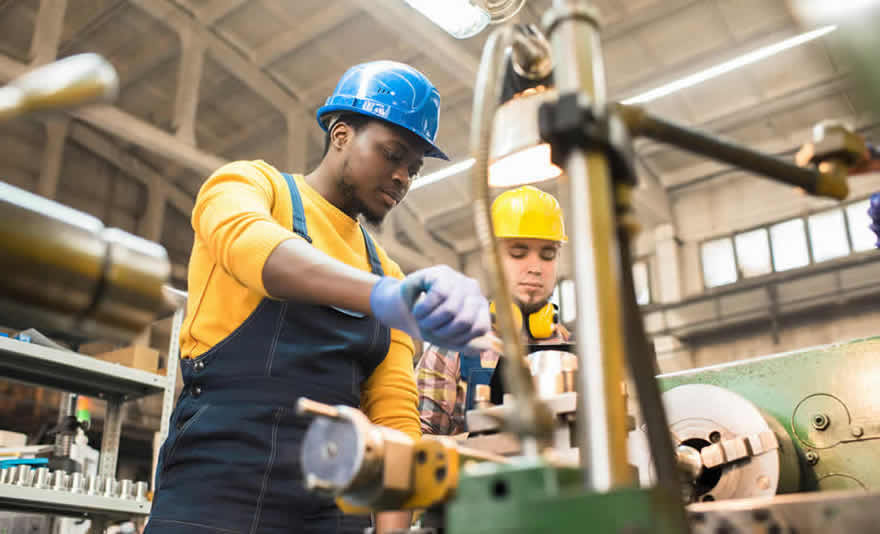 Image: Two industrial engineers working with tools in a factory. © Fotolia
