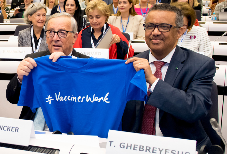 Jean-Claude Juncker a Dr. Tedros Adhanom Ghebreyesus držia tričko s nápisom „vakcíny fungujú“