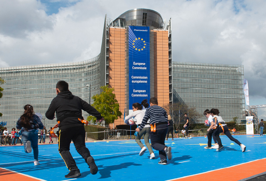 Mladí ľudia hrajú rugby na ihrisku pri Európskej komisii