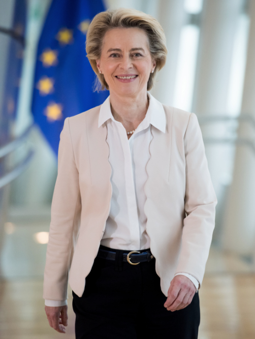 A portrait of Ursula von der Leyen walking towards the camera.