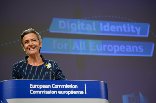 Margrethe Vestager smiling while standing at a podium.
