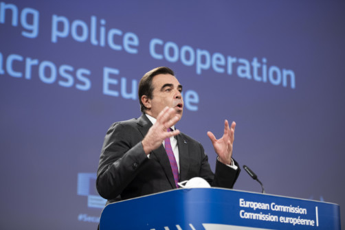 Margaritis Schinas gestures while delivering a speech at a podium.