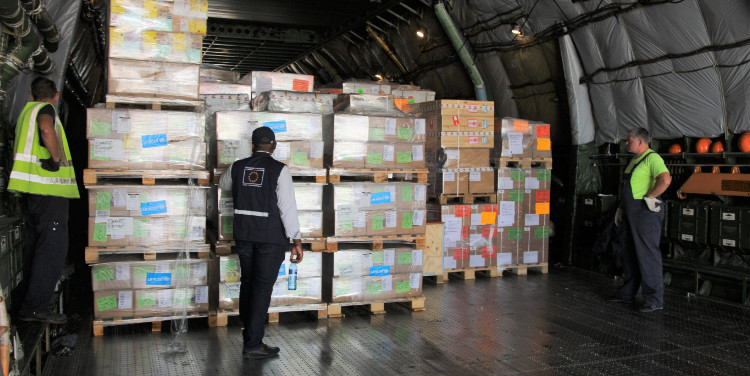 Aid workers inspect a shipment of cargo.