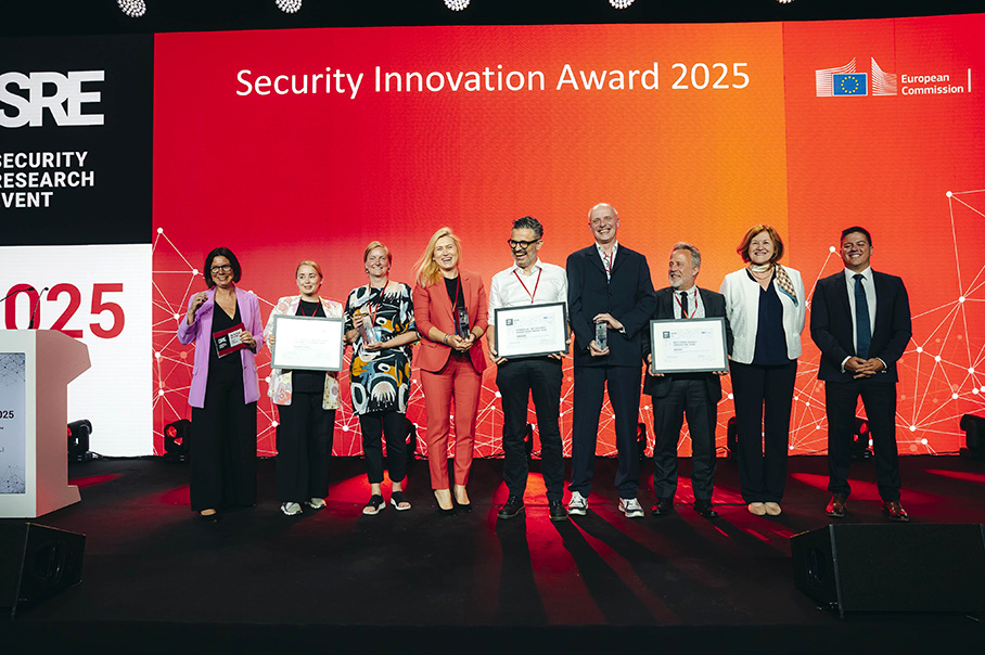 A group photo of award recipients, standing in front of a backdrop that displays the words, ‘Security Innovation Award 2025’.